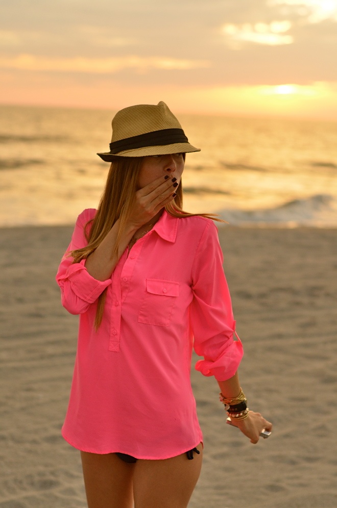 hot pink button up collared shirt, black bikini, black nails, lots of bracelets, and cute panama hat.